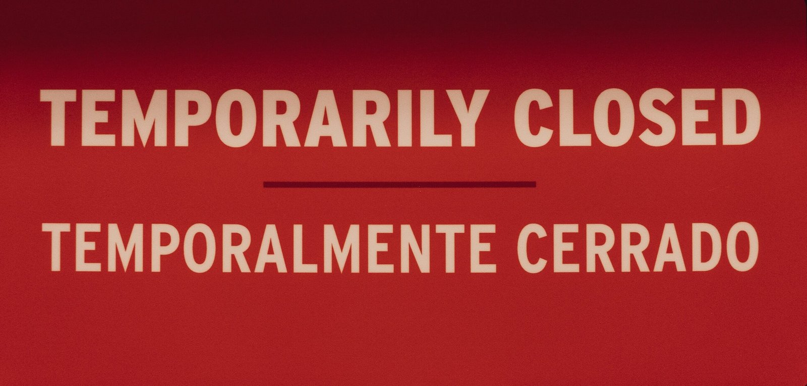 a close up of a red sign with white lettering