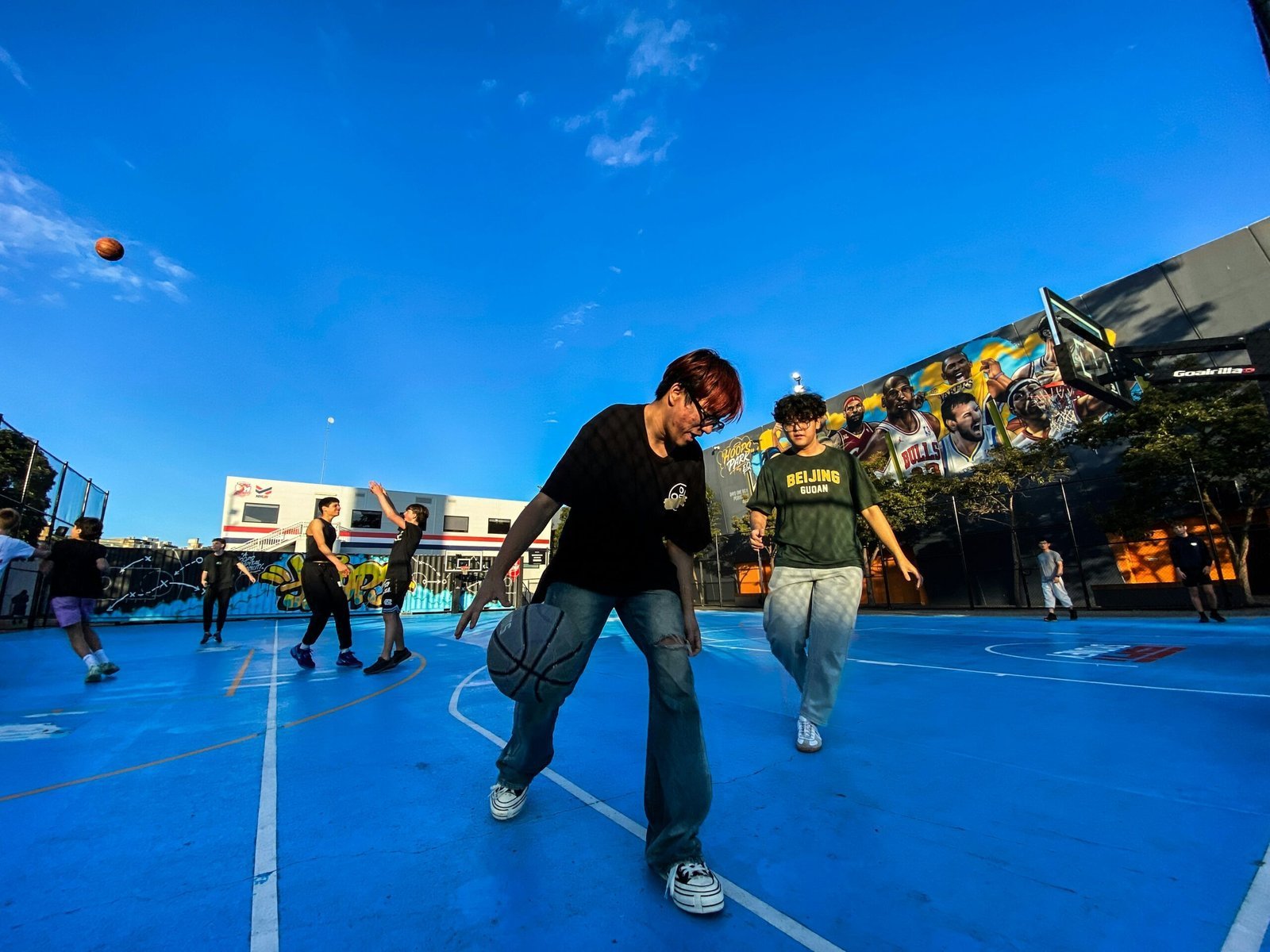 A group of young men playing a game of basketball